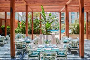a patio with tables and chairs and a potted plant at Four Seasons Hotel Cairo at Nile Plaza in Cairo