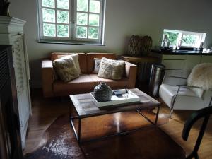 a living room with a couch and a coffee table at Forest Villa, Kaatsheuvel in Loon op Zand
