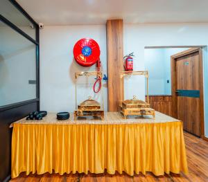 a table with a yellow table cloth in a room at Treebo Lake City in Bhopal