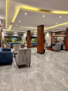 a lobby with chairs and couches in a building at Al Muhaidb Residence Al Maidan in Hafr Al-Batin