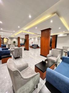 a lobby with couches and chairs and a table at Al Muhaidb Residence Al Maidan in Hafr Al-Batin