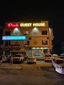 a guest house with cars parked in front of it at PAK HOTEL Islamabad in Islamabad