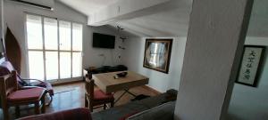 a living room with a couch and a table at Atico centrico ideal en Algodonales in Algodonales