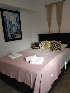 a bedroom with a large bed with towels on it at demis Mykonian soul 2 in Platis Gialos