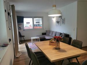 a living room with a table and a couch at Alpenchalet Pitztal in Sankt Leonhard im Pitztal