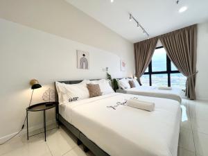 two beds in a room with white walls and windows at HighPark Suites Kelana Jaya, Petaling Jaya by Sleepy Bear in Petaling Jaya