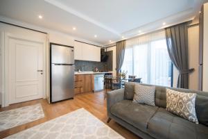 a living room with a couch and a kitchen at Saygın Apartments in Istanbul