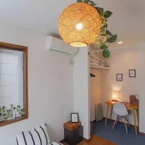 a room with a bed and a table and a chandelier at 直达-池袋-2分钟 车站徒步6分钟 3bedrooms in Tokyo