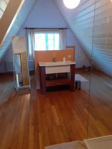 a attic room with a sink and a window at Ferienhaus Wietsche in Burscheid
