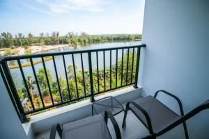 a balcony with chairs and a view of a river at Mantra Beach Condominium Suite 2 - Mae Phim in Ban Tha Fat