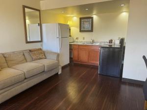 a living room with a couch and a kitchen at Super 8 by Wyndham Giddings in Giddings
