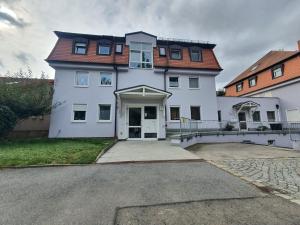 a large white house with a large driveway at Dennis Apartment in Dresden