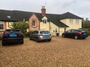 two cars parked in front of a house at Cleaver Cottage in Andover