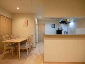 a kitchen and dining room with a table and chairs at Sumiyoshi Marie - Vacation STAY 12160 in Osaka