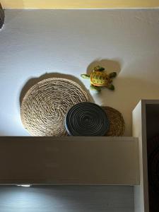 a shelf with two plates and a turtle on it at B&B La Bastia in Scilla