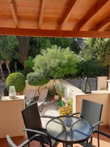Nea Paphos的住宿－Limnaria Deluxe Maisonette，庭院里设有桌椅。