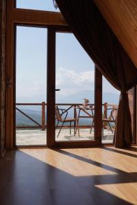 a room with a table and a view of the ocean at Villa deluxe n'Bjeshkë in Dragash