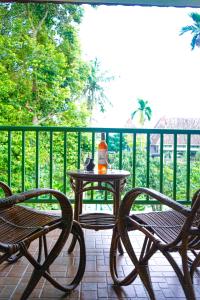 a table and two chairs sitting on a patio at Hotel Deli River and Restaurant Omlandia in Medan