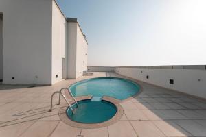 a pool in the middle of a building at Spacious Studio apartment in the Heart of JLT in Dubai