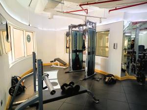 a room with a gym with weights and treadmills at Spacious Studio apartment in the Heart of JLT in Dubai