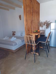een slaapkamer met een bed en een tafel en stoelen bij Sonia`s luxury apartment with jacuzzi in Kamilari