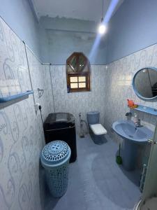 a bathroom with a sink and a toilet and a mirror at Pasidu Villa in Kalutara