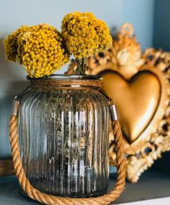 a vase filled with yellow flowers on a table at Palm Beach in Ajaccio