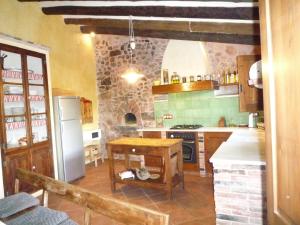 a kitchen with a refrigerator and a stove top oven at Masia Sapera in Pontons