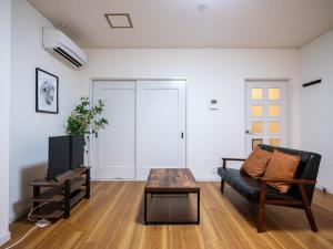 a living room with a couch and a coffee table at Sumiyoshi Marie - Vacation STAY 12161 in Osaka