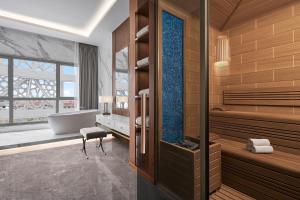 a bathroom with a tub and a bath tub at JW Marriott Hotel Istanbul Marmara Sea in Istanbul