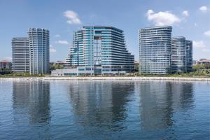 a group of tall buildings next to a body of water at JW Marriott Hotel Istanbul Marmara Sea in Istanbul