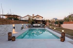 a swimming pool in the backyard of a house at Villa Fay in Lardos