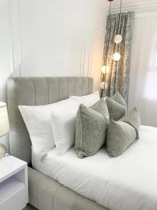 a white bed with pillows on top of it at Private Apartment at Ocean View Villas in Port Edward