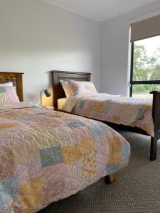a bedroom with two beds and a window at Long Island Retreat II (by the river with wi-fi) in Murray Bridge