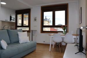 a living room with a couch and a table at Apartamento Alfa in Monforte de Lemos