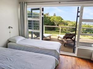 Habitación con 2 camas y balcón. en Beehaven Sunset Paradise, en Kenton on Sea
