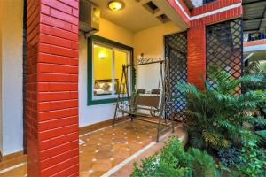 a porch of a house with a chair on it at La Goa Villa - 4BHK Baga JAQK Holidays in Baga