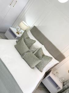 a bedroom with a bed with pillows on it at Private Apartment at Ocean View Villas in Port Edward