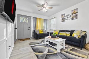 a living room with a couch and a table at NEW! Modern Comforts w/ 4Beds/3BR Sleeps 8 in Atlanta