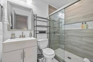 a bathroom with a shower and a toilet and a sink at NEW! Modern Comforts w/ 4Beds/3BR Sleeps 8 in Atlanta