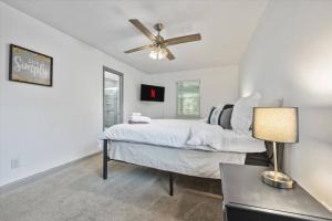a bedroom with a bed and a ceiling fan at NEW! Modern Comforts w/ 4Beds/3BR Sleeps 8 in Atlanta