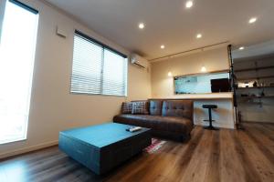 a living room with a couch and a table at 【 STAY Chill ~omura~】長崎空港から車で10分！ in Omura