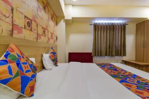 a bedroom with a large white bed in a room at FabHotel Vishala in Ahmedabad