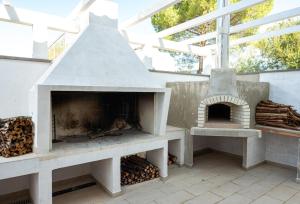 un patio con un horno al aire libre con techo en Ollu e Stentu, en Dolianova