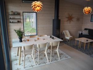 a dining room with a white table and chairs at Scandinavian lakeside cottage in Rovaniemi