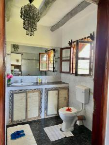 a bathroom with a toilet and a sink at Tembo village Watamu in Watamu