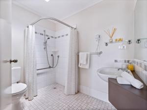 a bathroom with a shower and a toilet and a sink at The Noble Grape Guesthouse in Cowaramup