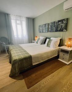a bedroom with a large bed and a night stand at Premium Beach apartment avec grande terrasse privée Les Cerisiers in Flic-en-Flac +13 photos