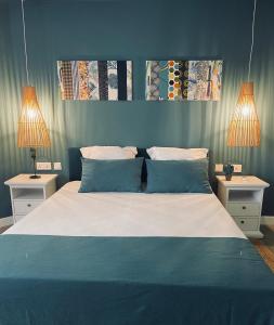 a bedroom with a large bed with two night stands at Premium Beach apartment avec grande terrasse privée Les Cerisiers in Flic-en-Flac