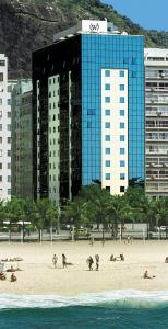 a group of people on a beach with buildings at Windsor Excelsior Copacabana in Rio de Janeiro